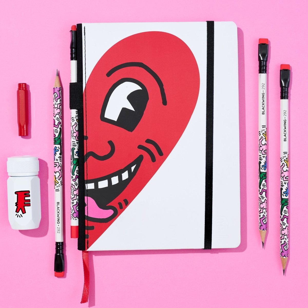 Flat lay of the gift set components, with sketchbook displaying the large red “Smiling Heart” illustration.