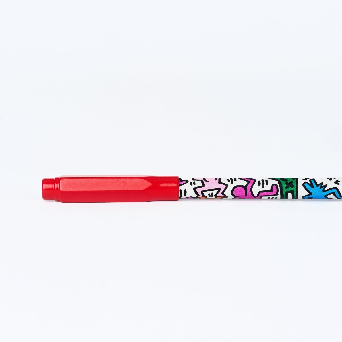 Side view of the point guard fitted onto the end of a pencil.