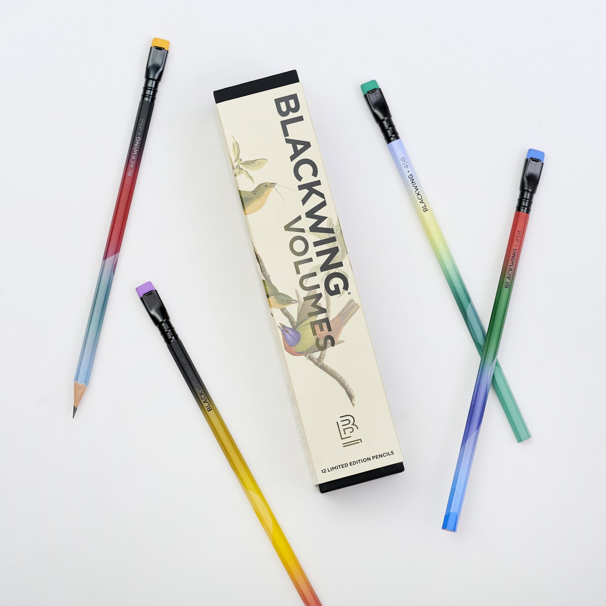 Blackwing Volume 458 pencils with gradient barrels arranged beside the box on a white background.