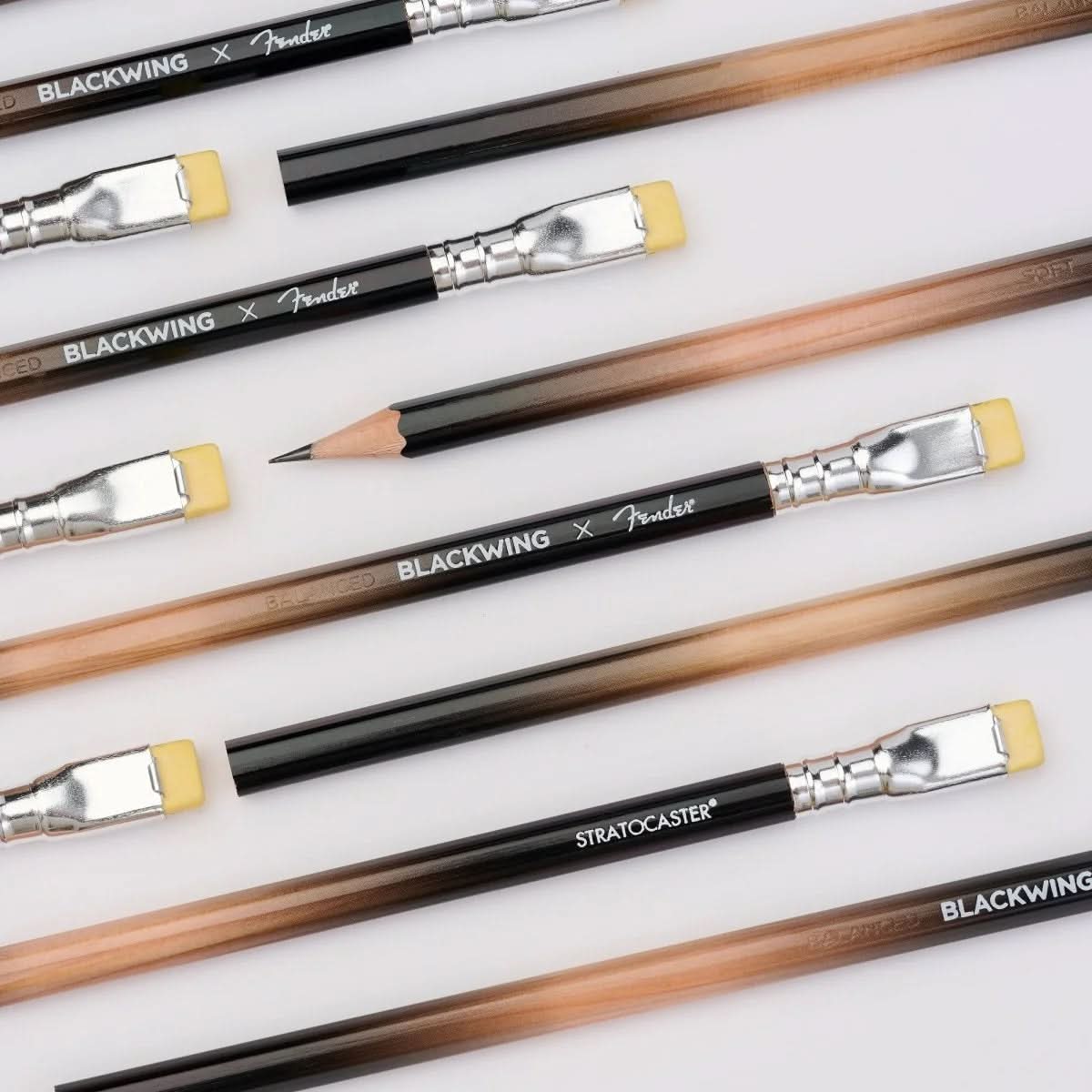 Flat lay of multiple Blackwing x Fender Limited Edition Pencils showcasing their sunburst finish and branding.