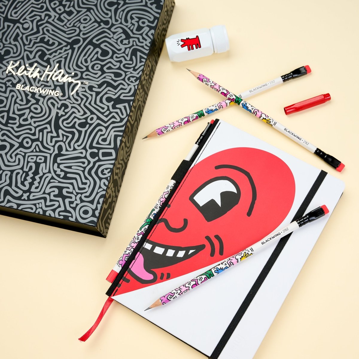 Close-up of the gift set contents laid out, including sketchbook, pencils, sharpener, and eraser.