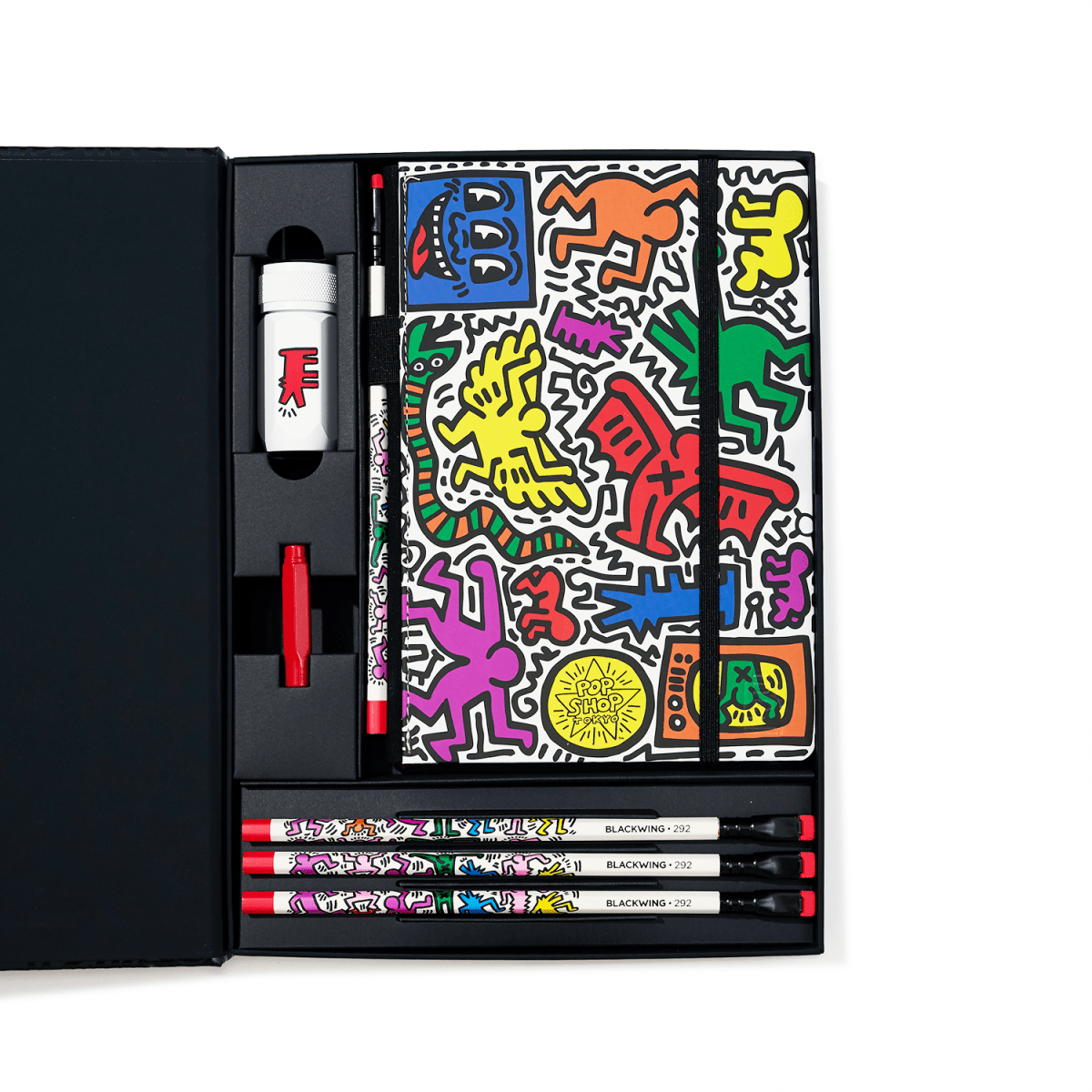Open Blackwing Keith Haring gift set showing four pencils, sharpener, eraser, and colourful “Tokyo Pop-Shop” sketchbook in a black box.