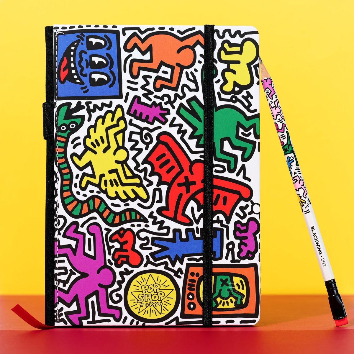Flat lay of the notebook and matching Blackwing pencil on a bright yellow background.