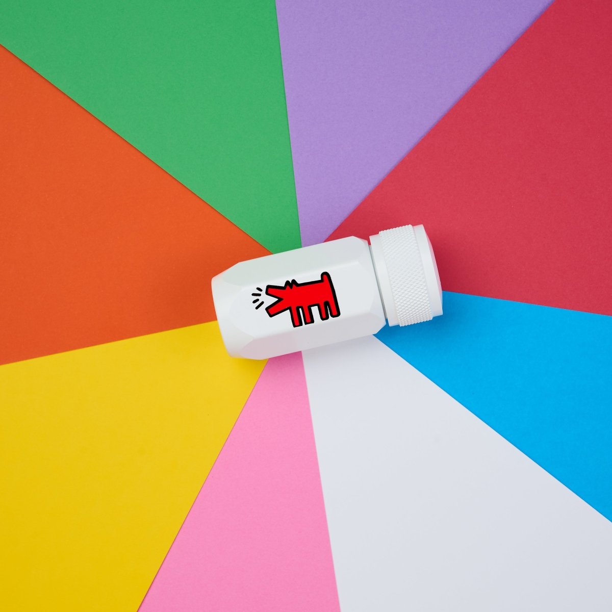 Flat lay of the sharpener on a colourful geometric background, showcasing the playful design.