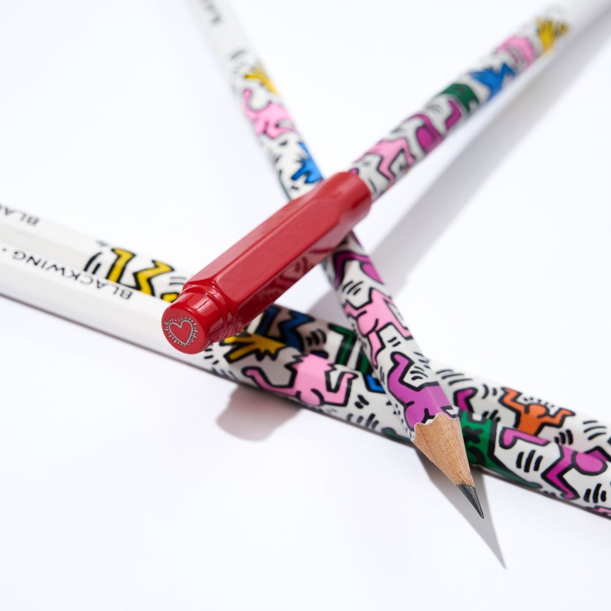Top view of the point guard placed on a group of Blackwing Volume 292 pencils with Haring designs.