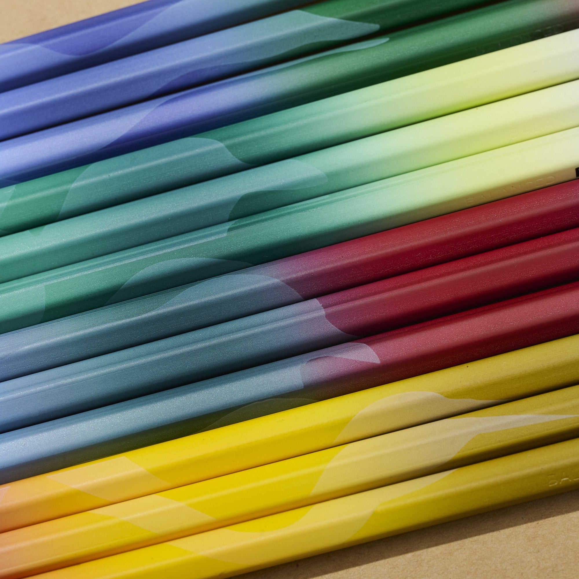 Blackwing Volume 458 pencil barrels close up showing colourful satin gradients and a feather motif.