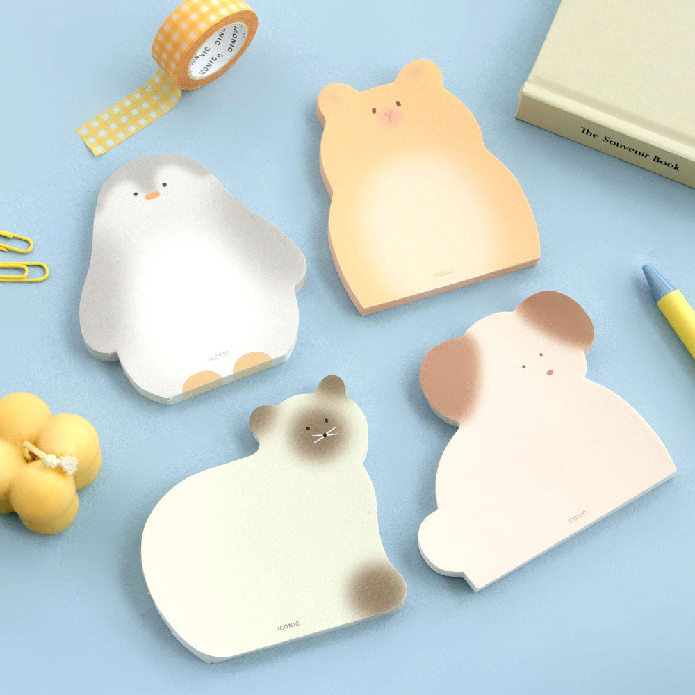 A set of Iconic Animal Memo Pads shaped like cute animals, including a penguin, cat, and dog, displayed on a light blue background with stationery.