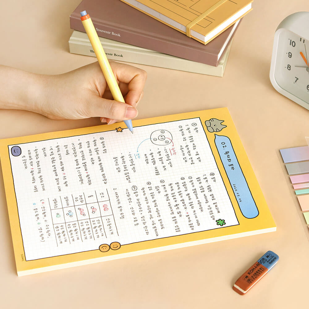 Iconic B5 Doodle Grid Notepad yellow cover version open with handwritten notes.