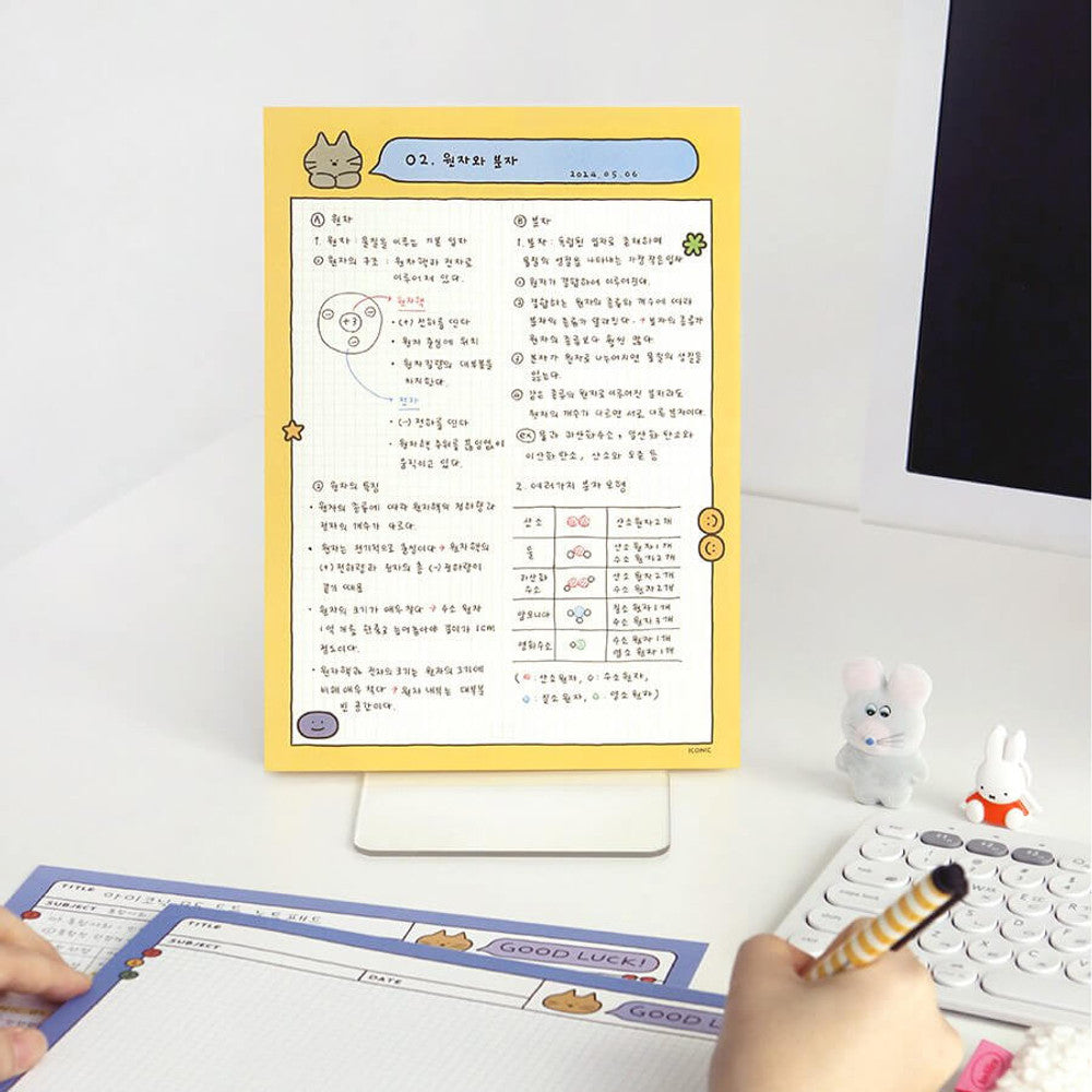 Iconic B5 Doodle Grid Notepad set in yellow and black displayed together with stationery accessories.