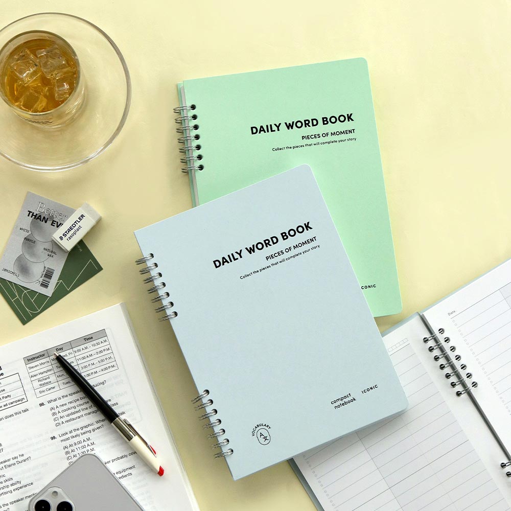 Iconic Daily A5 Word vocabulary notebook in mint green cover with pen and tea on desk.