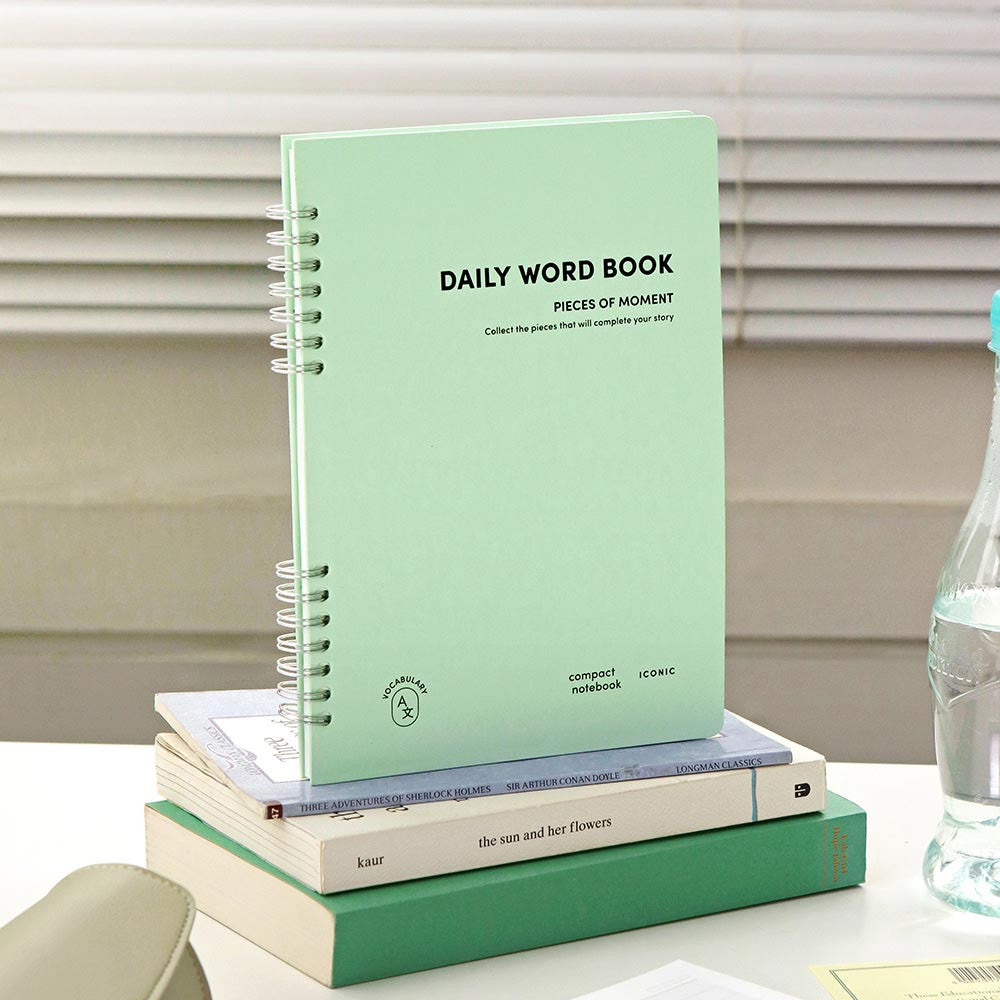 Iconic Daily A5 Word Vocabulary Notebook in mint green cover standing on desk.