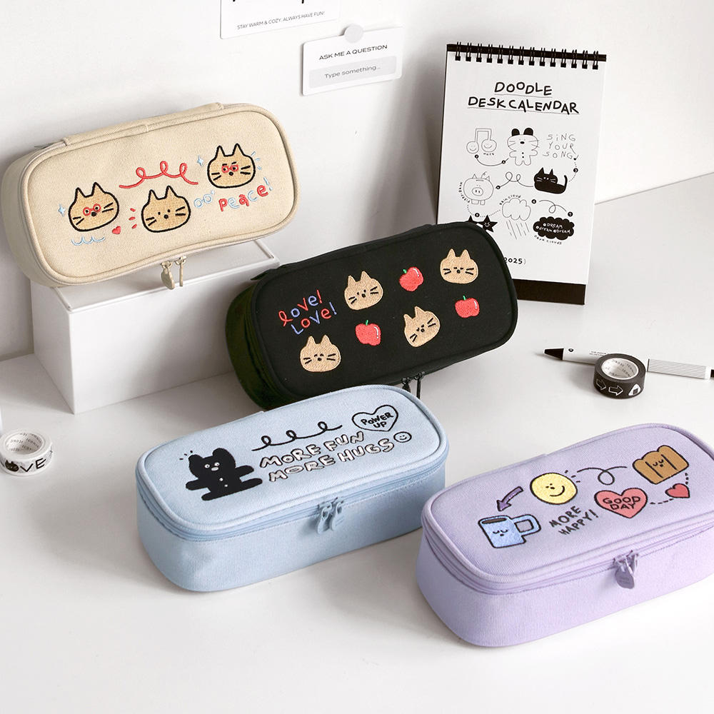Iconic Doodle Printed Large Capacity Pen Case in cream, black, blue, and lavender with cute character illustrations on lids.