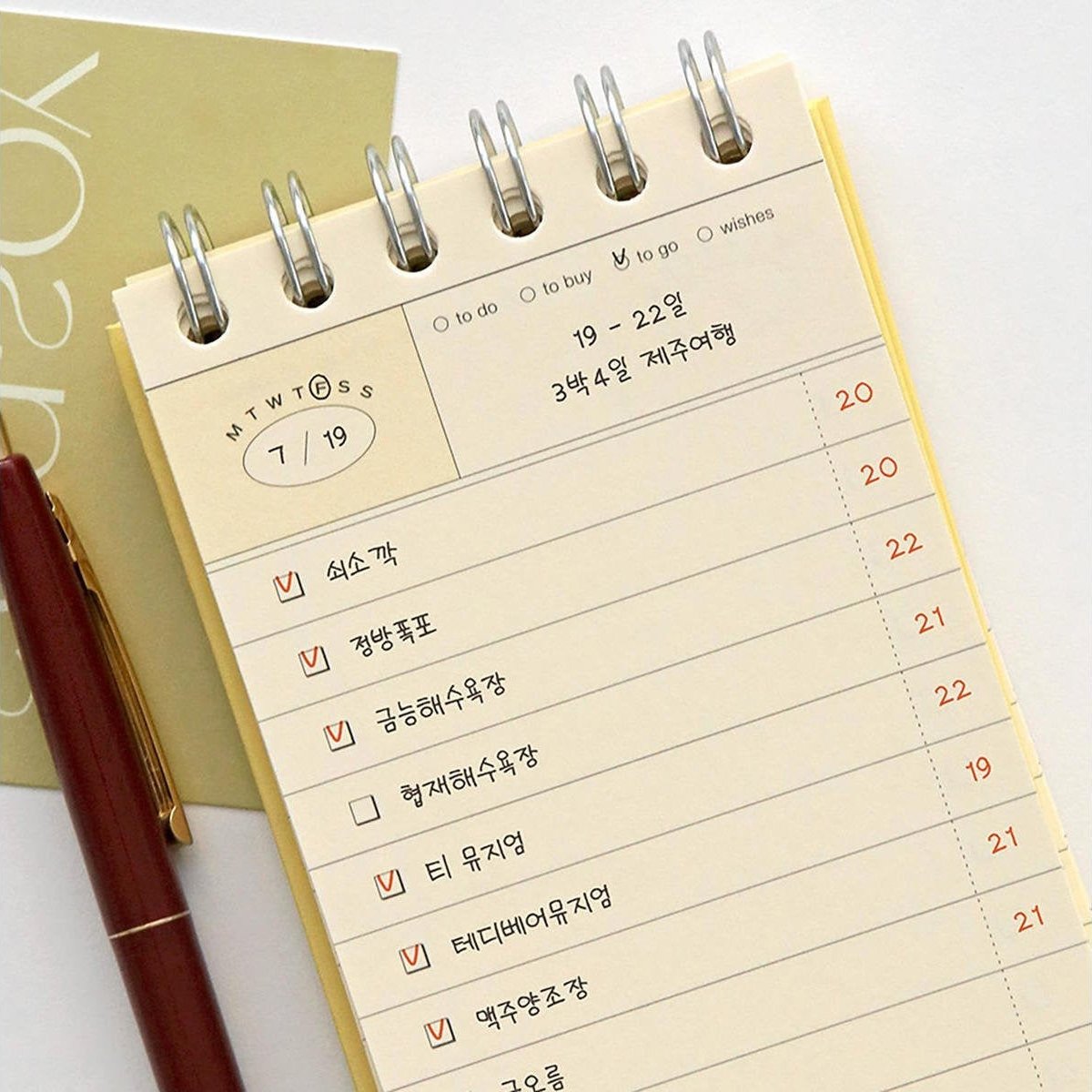 A close-up of the yellow Iconic Flow Checklist showing neatly printed task lines and date columns for six-month planning.