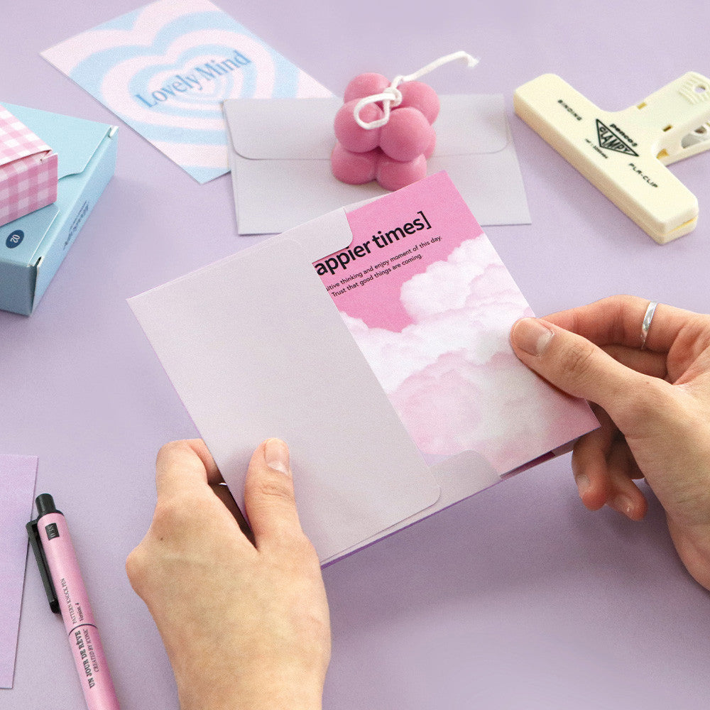 Person preparing Iconic Moodscape Message Card pink version with matching envelope.