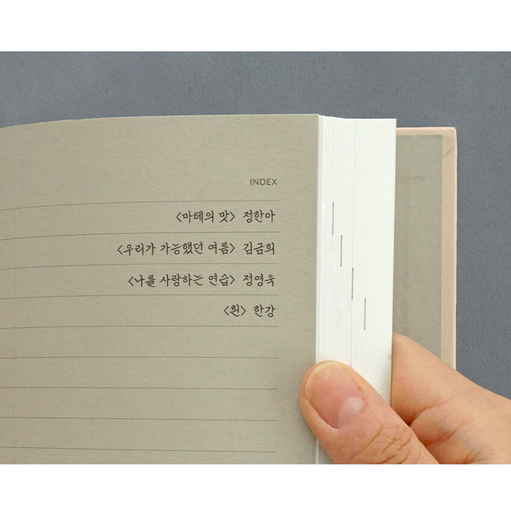 Iconic Solitude Tomoe River Line Notebook close-up of lined pages with neat handwriting.