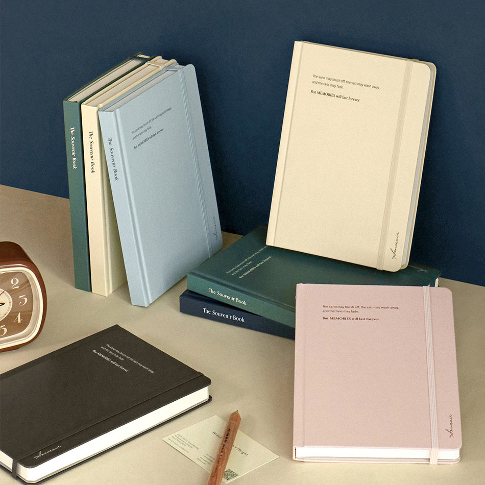 Iconic Souvenir B6 Lined Band Notebook lined hardcover journals displayed in assorted colours including pink, beige, blue, and dark green.