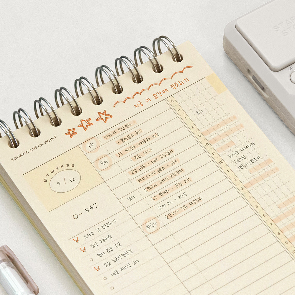 Iconic Undated Flow Spiral Study Planner open showing neatly organised daily timetable and notes layout.